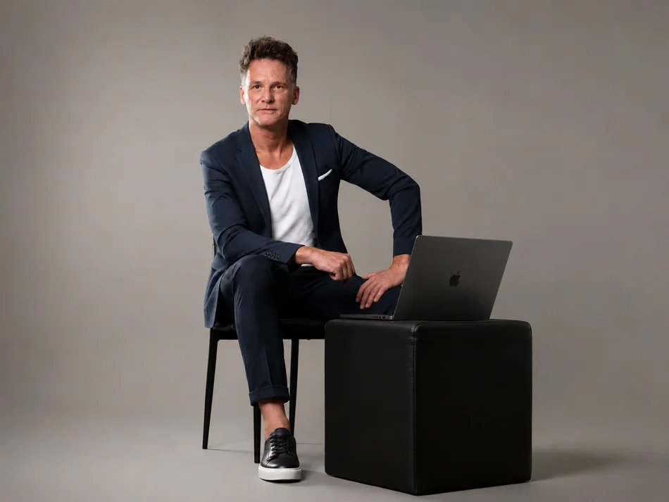 Chris sitting with a laptop